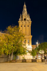 Illuminated Stone Tower Over City Park
