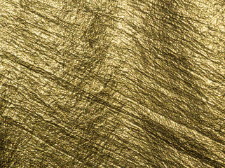 Gold. Golden background. Golden fabric. Golden fabric background. Luxurious textile surface. Abstract golden background with texture. Fabric shiny glitter texture. Luxurious background. Golden color. 