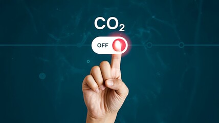 Hand finger pressing an onoff switch to turn off co2 emissions against a dark blue digital background symbolizing environmental control and carbon reduction strategy