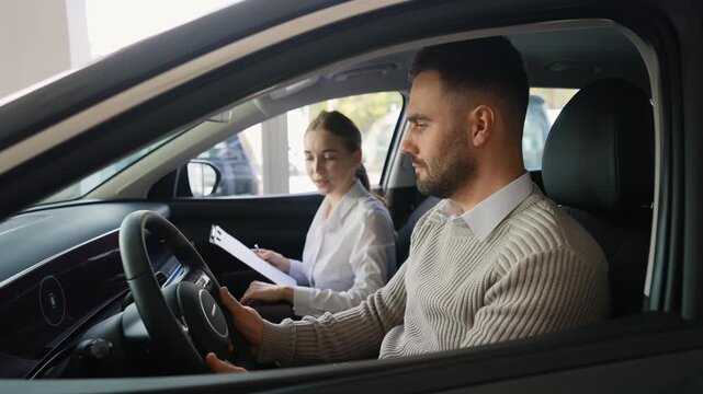 Saleswoman consulting a male customer testing a new car
