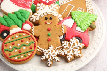 Tasty gingerbread cookies, marshmallows and Christmas decor on white textured table, closeup