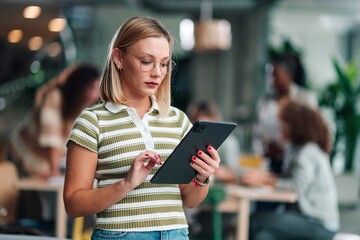 Woman using digital tablet in modern office
