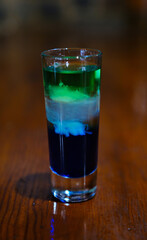 Rainbow drink. Glass shot of alcohol liquor. Bar counter. Rainbow colors. Colored vodka. LGBT Pride. Rainbow flag, symbol gays and lesbians LGBT, LGBTQ. Good for Party. Rainbow.