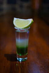 Gold tequila shot with lime isolated on white background. Shot lime drink