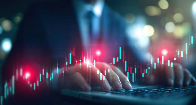 Hands type on keyboard with vibrant financial trading charts displayed overhead.
