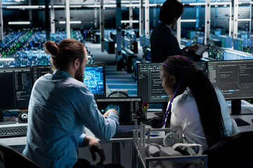 Teamworking server farm colleagues deploying AI tools to automate repetitive workflows. Team of...