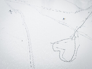 Aerial view of snowy expanse crisscrossed with trails of footprints, a story etched in white, Trakai, Trakai, Lithuania.
