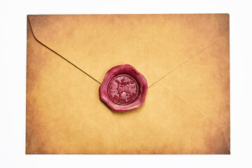 Sealed Vintage Envelope. A brown vintage envelope sealed with a red wax stamp featuring an intricate design.