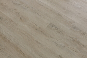 Light oak home flooring photographed with shallow depth of field, showcasing natural grain patterns and modern interior finishes.