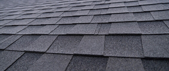 Selective focus texture of dark gray asphalt roof shingles