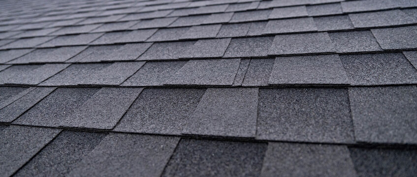 Selective focus texture of dark gray asphalt roof shingles