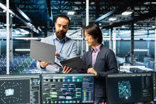 Engineers coding in data center, updating AI driven automation scripts. IT employees working in server farm programming artificial intelligence algorithms, debugging equipment