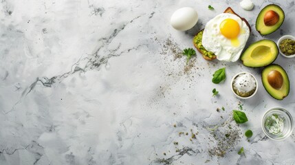 A high-key overhead composition of a fried egg on avocado toast with avocado halves, spices, and an egg on a marble surface. Perfect for brunch and recipe content