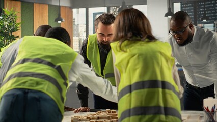 Real estate professionals using architectural software to refine housing layouts and 3D models. Development team collaborates on zoning regulations and property investment strategies.