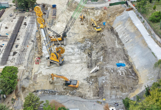 Aerial view of heavy machinery at Halkalı Merkez construction site, with cranes and excavators amidst raw earth and concrete forms, Istanbul, Istanbul, Turkey.