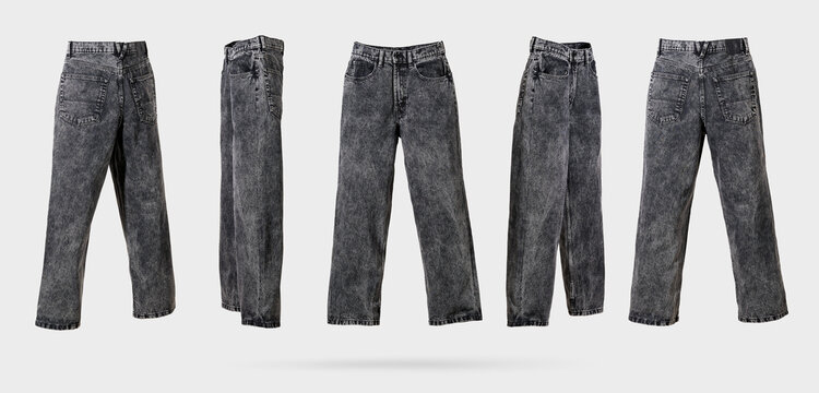 Black male acid wash denim jeans with wide leg and fading from different sides on light gray background. Concept of trendy vintage, men's street fashion denim clothing. Template for design. Banner