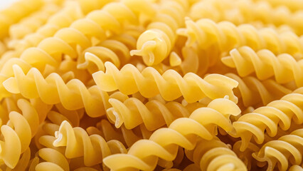 Celebrate Italian culinary traditions with a heap of fresh, uncooked fusilli pasta, perfect for your next delicious recipe or food blog post
