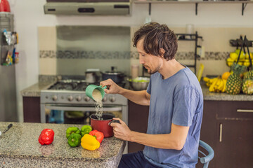Man preparing lunch in an authentic modern kitchen with character, cutting ingredients and cooking a homemade meal in a warm family atmosphere