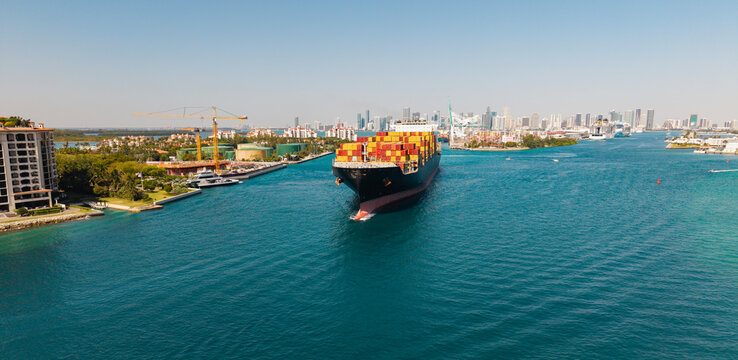 Cargo business. Container ship. Shipping logistics. Commercial shipping. Cargo ship in sea, aerial view. Freight container loaded on cargo vessel. Aerial cargo ship with container. Ship navigation