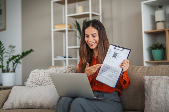 Woman presenting document during online video call at home - Powered by Adobe