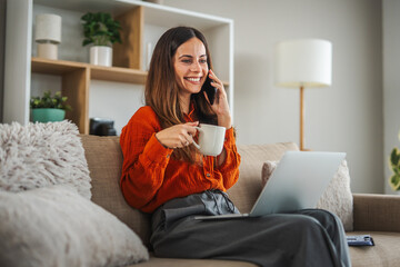 Woman working remotely from home talking on phone