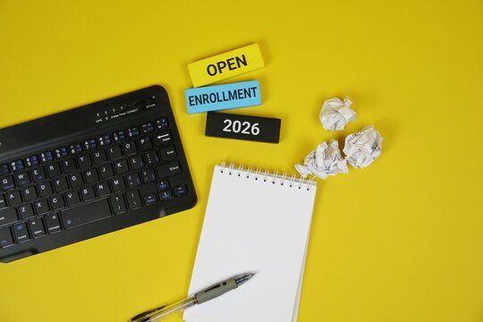 Yellow background featuring a laptop keyboard, spiral notebook, and pen, with colorful blocks showing Open Enrollment 2026. Great for education, courses, and business enrollment themes.