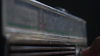 Adjusting frequency on a retro analog radio with the moving frequency bar clearly visible, showcasing vintage tuning interaction and signal search.