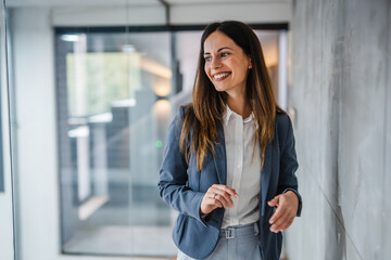 Confident businesswoman smiling in modern office environment