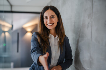 Businesswoman extending hand for a welcome or handshake