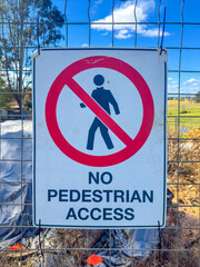 Photograph of a No Pedestrian Access sign on a fence barricade notifying people not to enter a small construction site in regional New South Wales, Australia. 