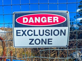 Photograph of a Danger Warning Sign on a fence barricade notifying people not to enter a small construction site in regional New South Wales, Australia. 