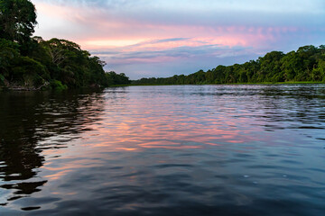 Sunset with a tour boat sailing along the canals in the Tortuguero National Park of Costa Rica
