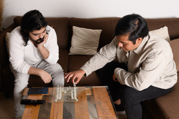 Two friends playing an intense and strategic game of chess