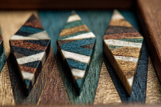 Colorful wooden game pieces arranged on a textured board in a well-lit setting