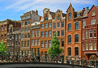 Fototapeta premium Canal Houses and Bridge with Bicycles Amsterdam Netherlands