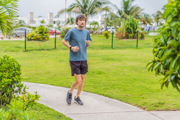 Man exercising in an urban park, stretching and training outdoors on a sunny day, concept of active lifestyle, health, motivation and daily body care in a natural real environment