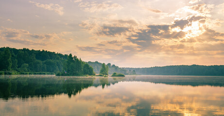 Fototapeta premium Lake with a cloudy sky in the background