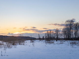 Snowy field with a beautiful sunset in the background