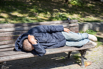 Man is sleeping on a bench
