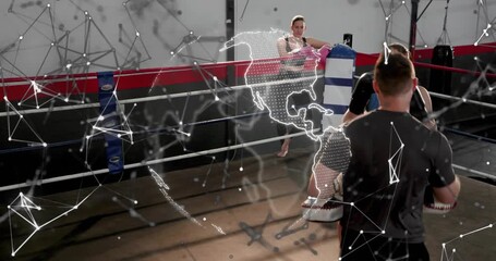 Female boxer doing boxing mitt drills while coach shifting mitts, globe overlay appearing over ring - Powered by Adobe