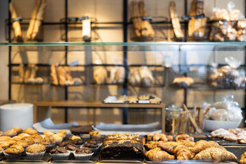 Showcase of traditional Spanish bakery shop with appetizing croissants, baguette and buns