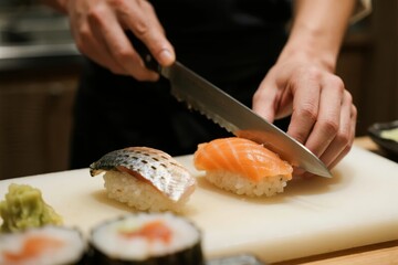 A chef prepares sushi on a cutting board, slicing salmon and arranging various types of sushi with precision.
