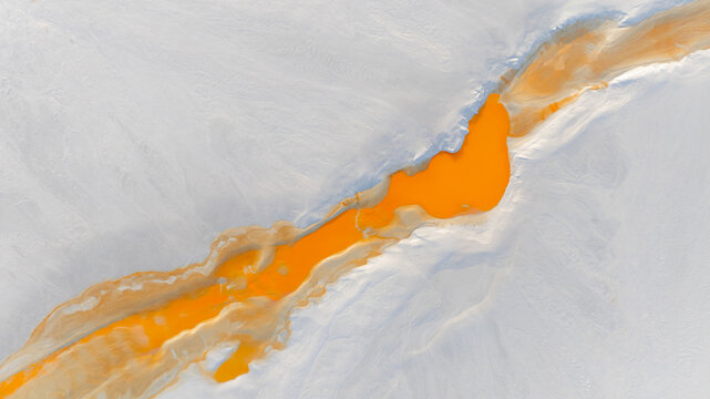 Aerial view of vibrant orange river snaking through a stark, pale landscape, a surreal contrast of colors and textures that captivates the eye, R&iacute;otinto, Andalusia, Spain.