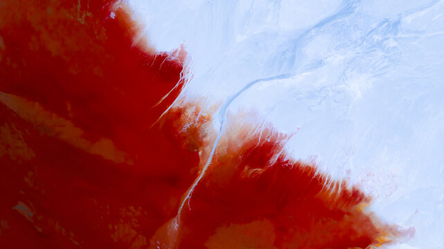 Aerial view of a river winding through starkly contrasting red and white landscapes, creating an otherworldly scene, R&iacute;otinto, Andalusia, Spain.