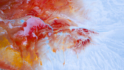 Aerial view of swirling, fiery hues blend with icy blues, painting a surreal landscape of contrasting textures and tones, Ríotinto, Andalusia, Spain.