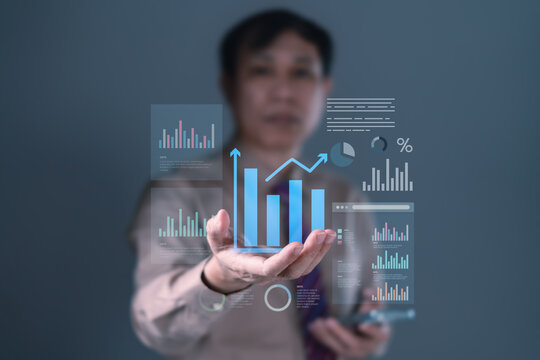 Businessman presenting financial data analysis with futuristic bar charts, pie graphs, and growth indicators for smart business strategy