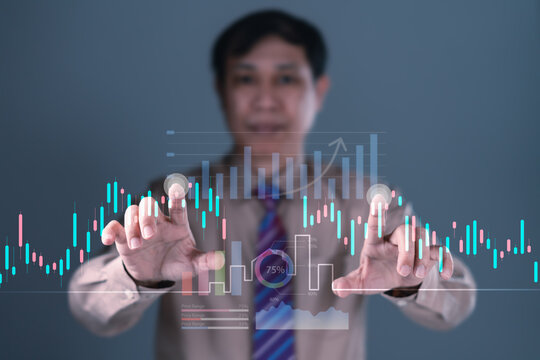 Businessman interacting with futuristic digital financial chart, candlestick and bar graph for investment data analytics