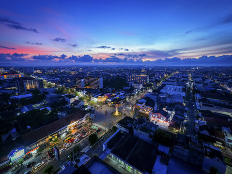 Aerial view of Tugu Jogja monument standing majestically under a twilight sky painted with hues of blue and orange, Yogyakarta, Daerah Istimewa Yogyakarta, Indonesia.