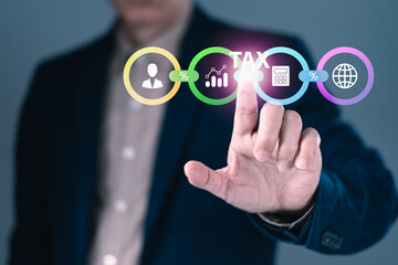 Businessman touching virtual tax icon with financial analysis and calculation elements for business accounting and taxation concept