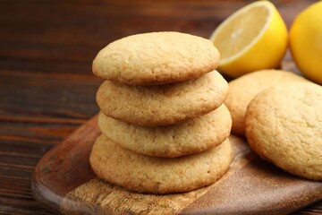 Tasty lemon cookies and fruits on wooden table, closeup